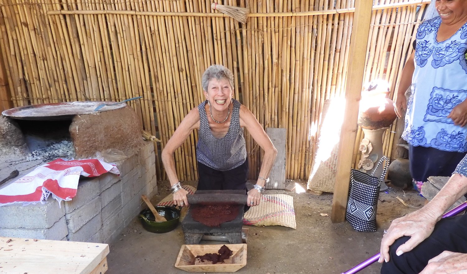The author attempts to grind cocoa beans.